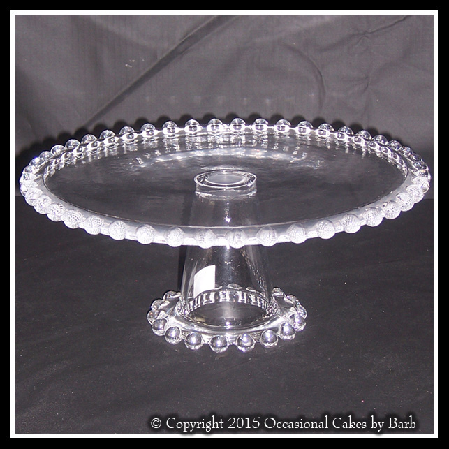 Glass stand with raised edge decoration