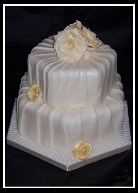 Two tier stacked hexagonal pleated wedding cake