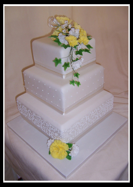 Three tier stacked square wedding cake