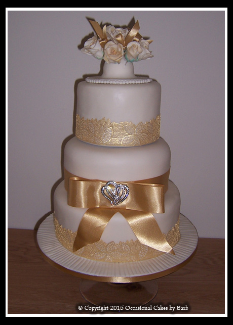 Three tier stacked round wedding cake with ivory icing