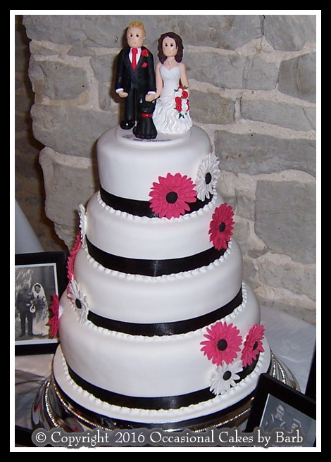 White & black four tier stacked round wedding cake