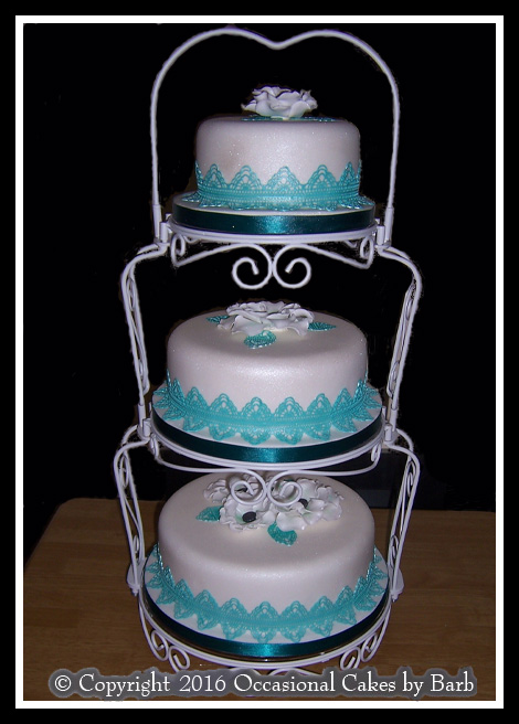 three tier white and turquoise cake