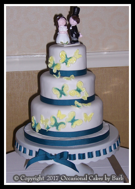 Teal and yellow butterflies wedding cake