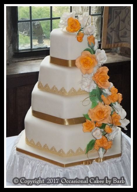 Tangerine and white rose cascade wedding cake