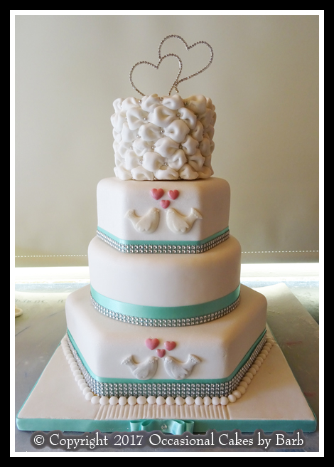 Four tier mixed round and hexagonal stacked wedding cake.