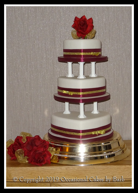 Burgundy and gold three tier heart cake