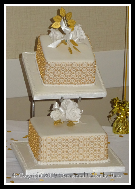 Gold and white two tier lace wedding cake